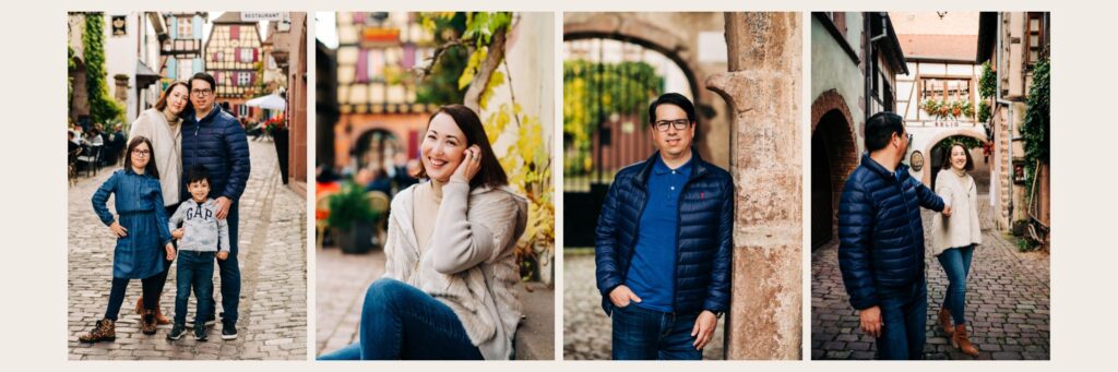 Family posing in medieval Alsace village for family portraits Woman smiling while sitting on stone bench surrounded by vines Father leaning against stone archway during family photo session Candid couple walking hand-in-hand through Alsace village alley